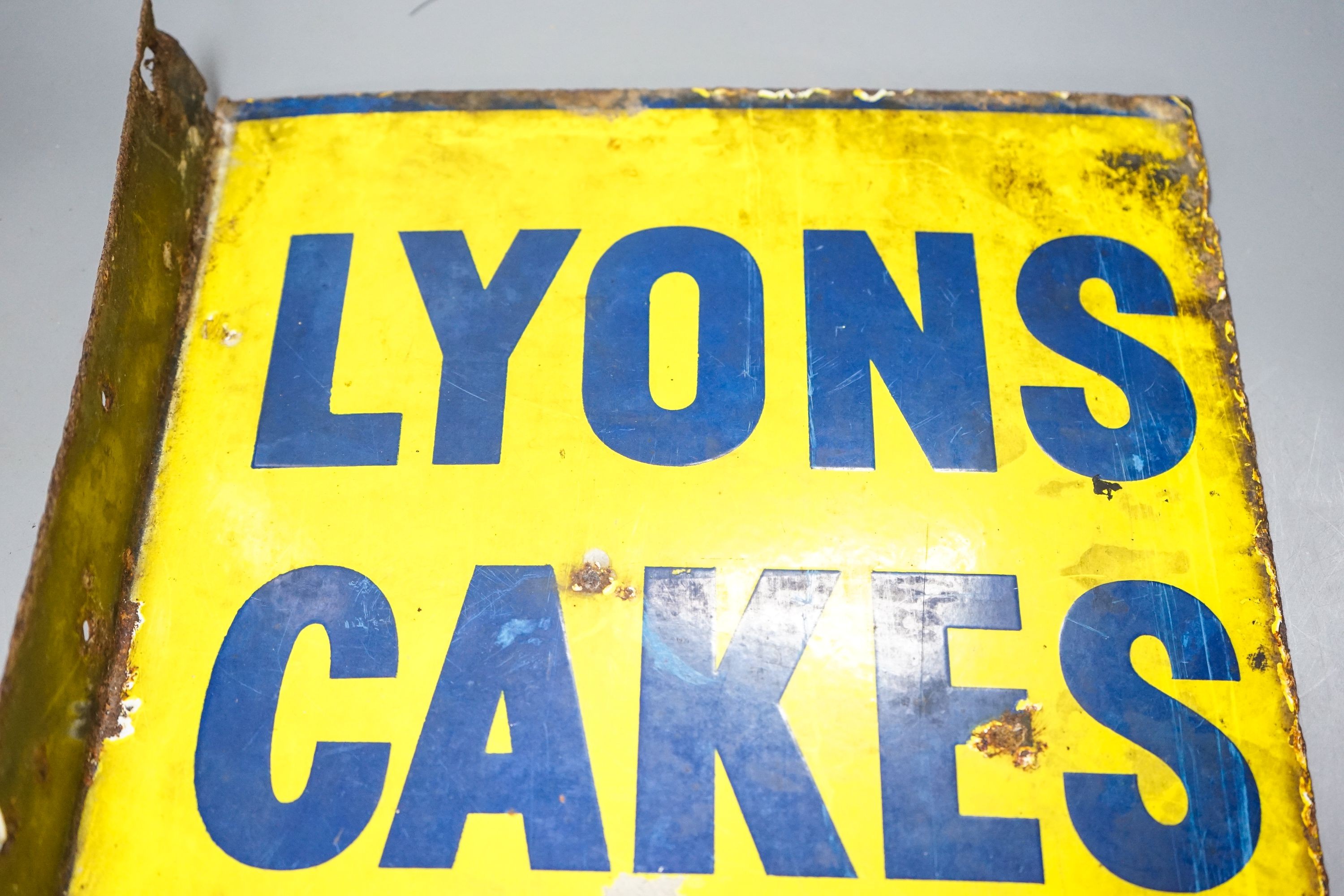 A Lyons Cakes yellow ground enamelled sign 40x32cm